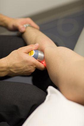 woman getting laser therapy on her leg
