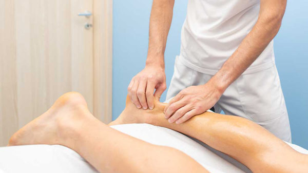 Physiotherapist assessing an Achilles tendon injury at Burlington Sports Therapy