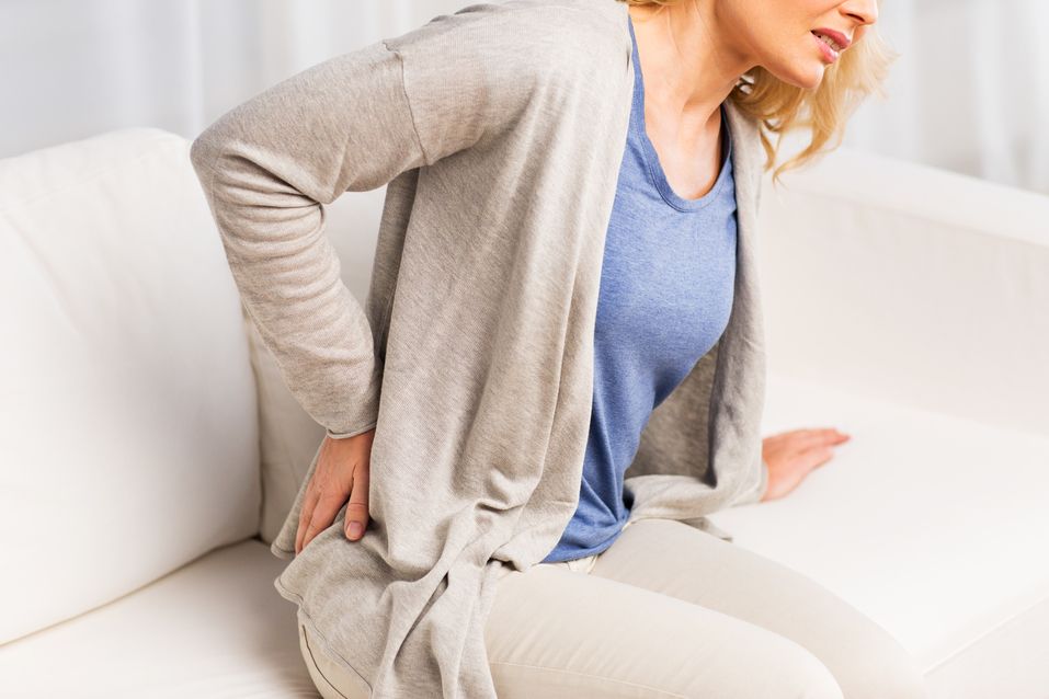 woman with backpain on couch