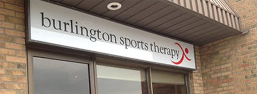 White Burlington Sports Therapy Sign with black text