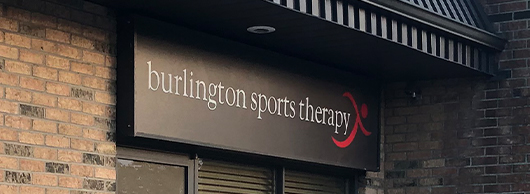 Black Burlington Sports Therapy Sign with white text
