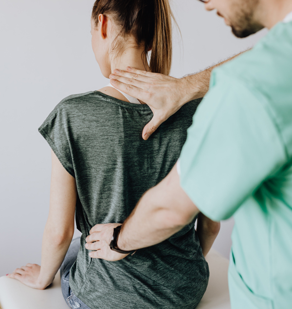 chiropractic adjustment on back of female patient