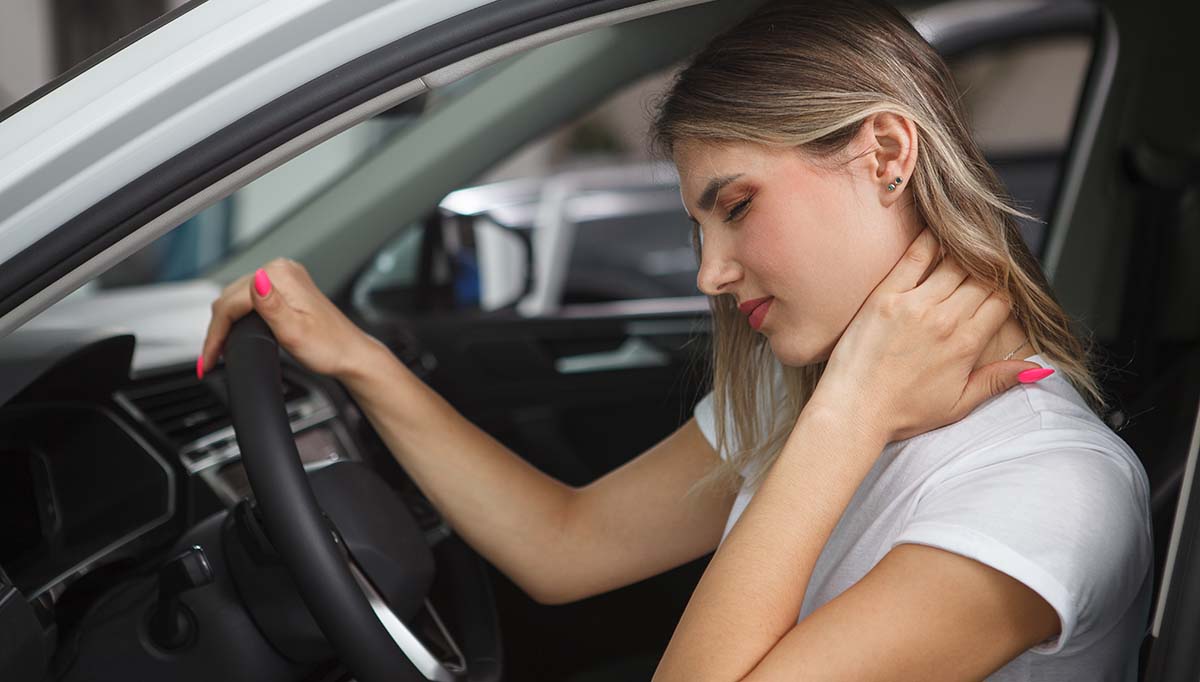 young woman hold neck due to whiplash following a car accident