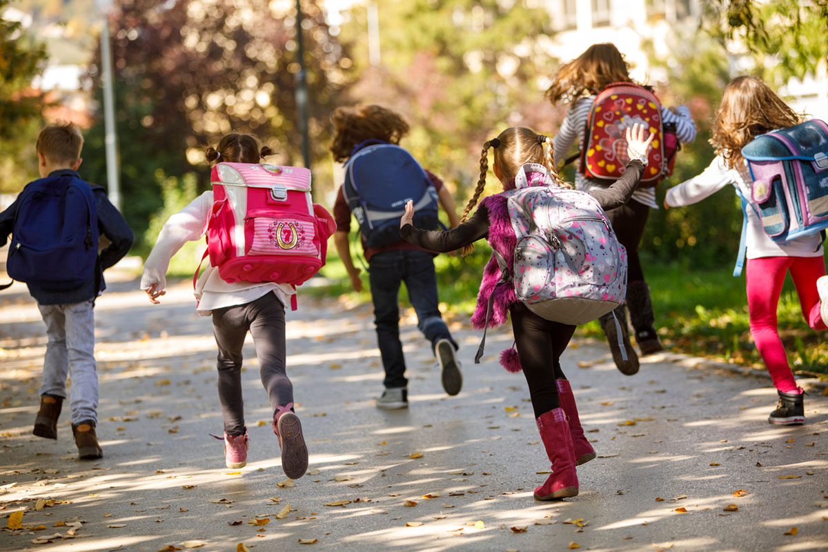 kids running with backpacks on