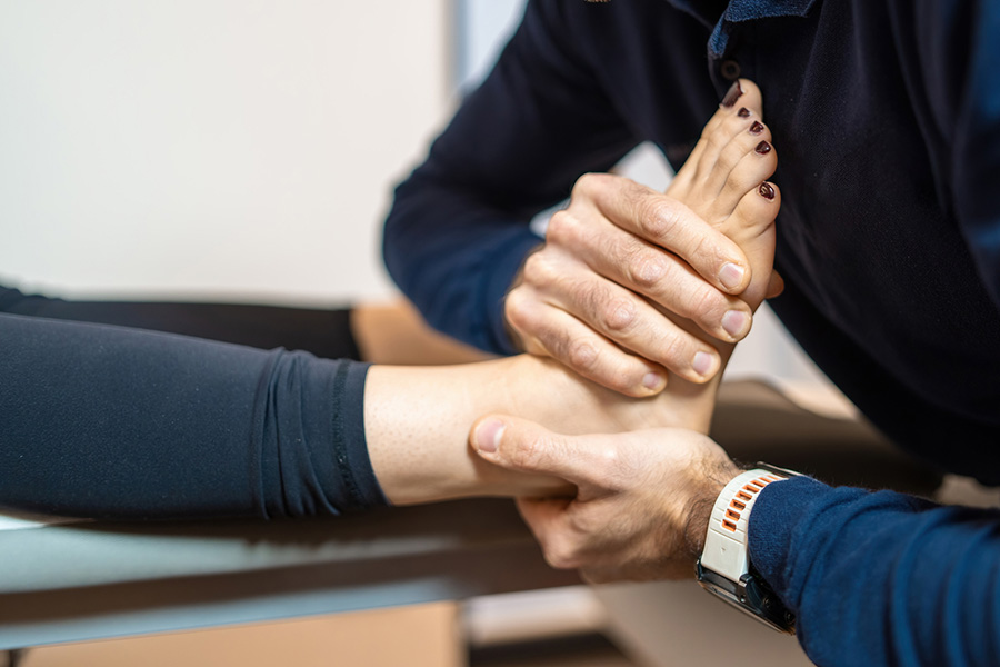 Physiotherapist administering ankle treatment