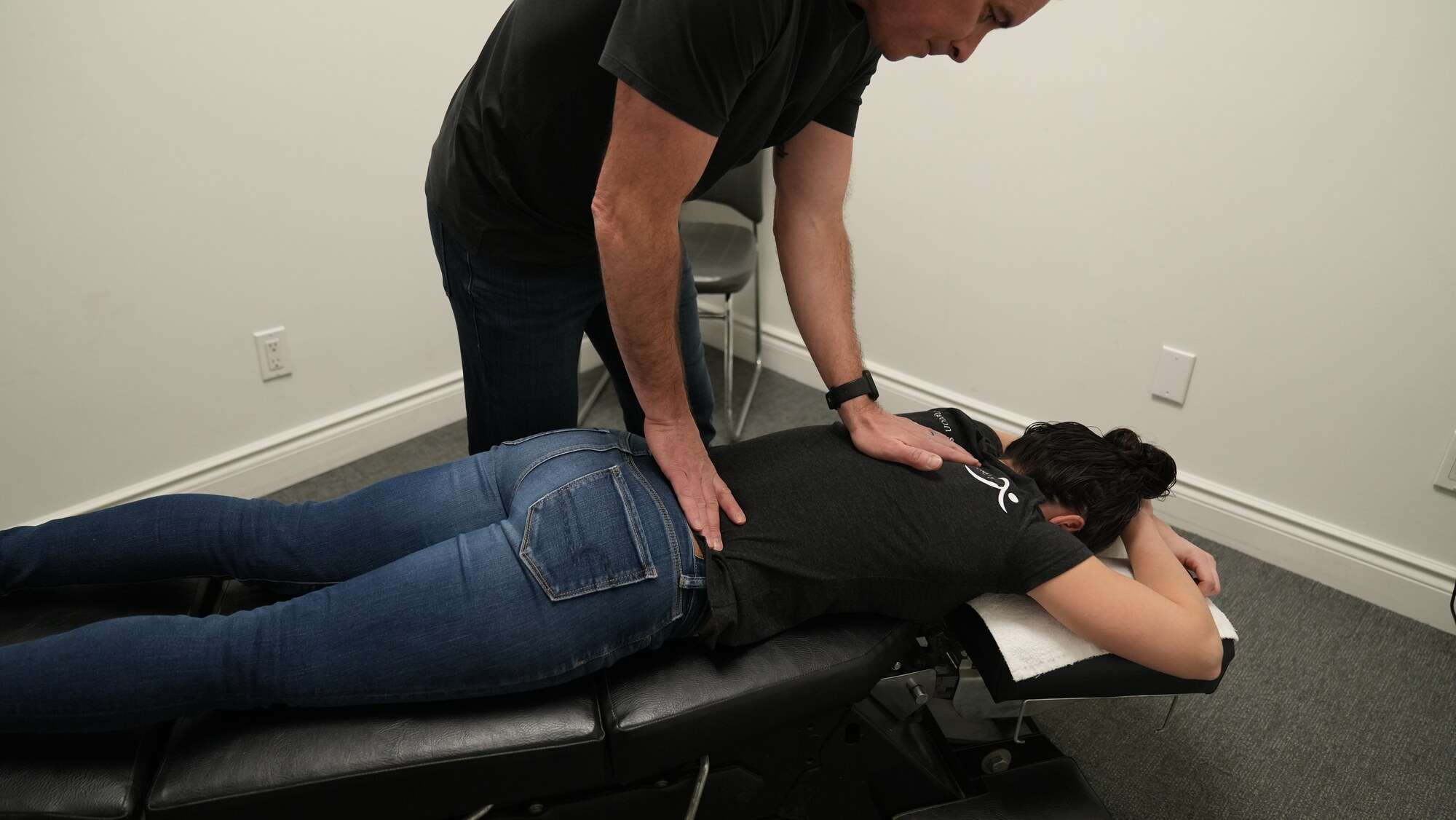 Sports therapy Burlington practitioner performing low back adjustment to help reduce pain and improve mobility