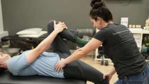 Physiotherapist assessing hip and knee movement at Burlington Sports Therapy