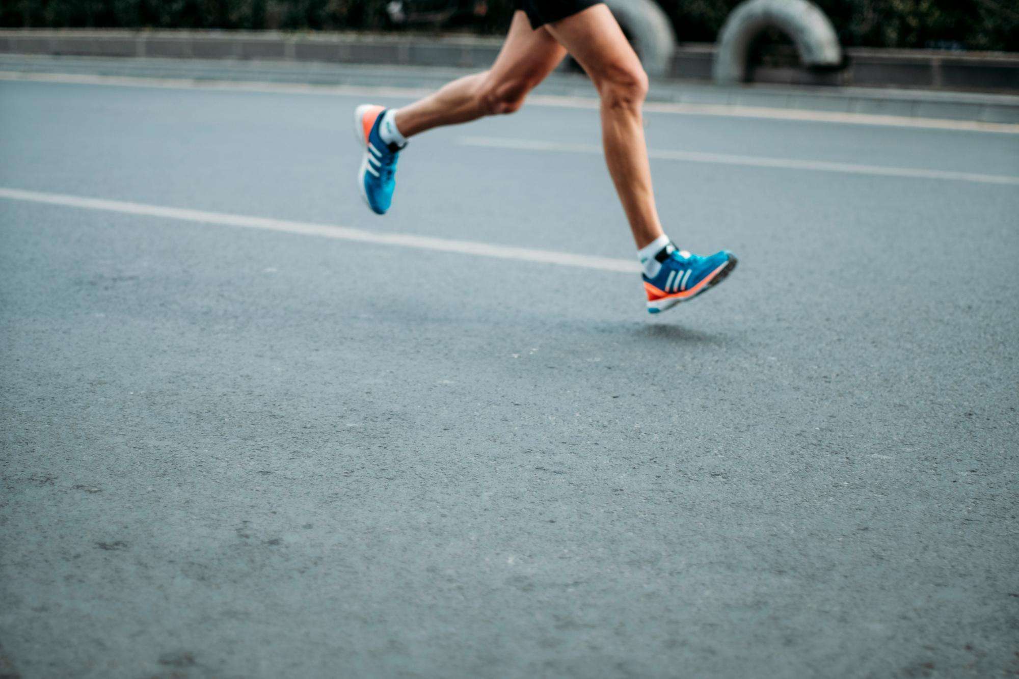 Runner in motion showing athletic form during outdoor exercise training session